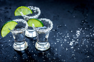 Set for tequila party with lime and salt on black background