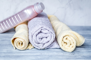 Fototapeta na wymiar housekeeping set with towels and plastic bottles on laundry back