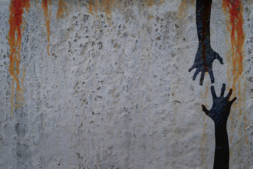Shadow of two corpse hands on concrete wall with blood drops background. Halloween theme...