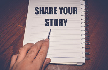 share your story written on white paper, business concept background