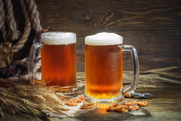Glasses of fresh beer on a wooden table.