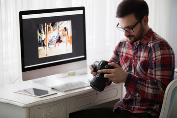 Portrait of young attractive man doing design work on computer