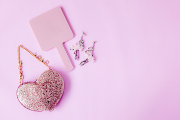 Smartphone with fashion accessories, cracker fancy,coffee mug, and Chocolate gold on pastel pink colors office table Mix for ladies and young girls using smart Phone On table desk in holidays .