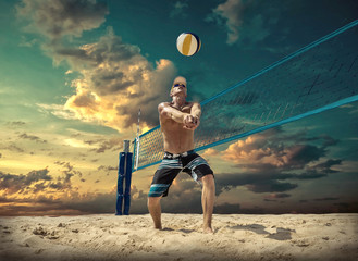 Beach volleyball player in action at sunny day under blue sky.