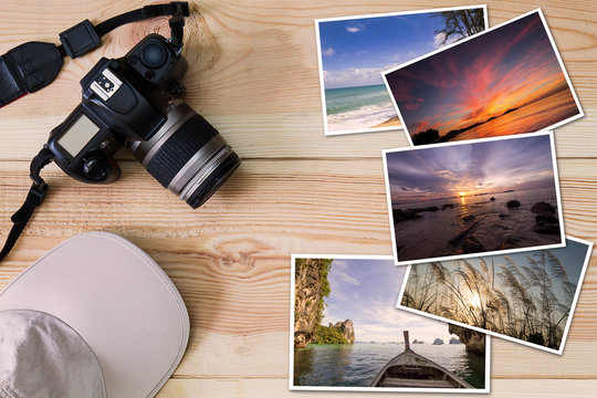 Old camera, cap and stack of photos on wooden background, photography hobby lifestyle concept