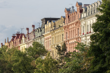 Karlovy Vary, Czech Republic - August 15, 2017:Colorful condominiums flanked by the streets of the city, with a row of trees