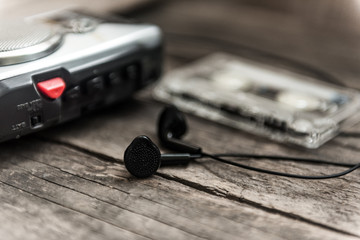 Vintage walkman cassette player with earbuds and tape cassette, retro style toned image