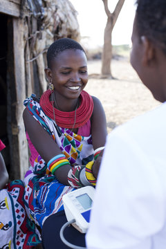 Nurse examining woman in Samburu village