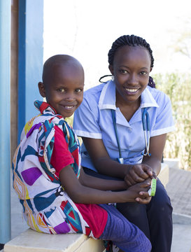 Portrait of Nurse and young girl in clinic. Kenya, Africa.