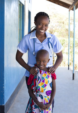 Portrait of Nurse and young girl in clinic. Kenya, Africa