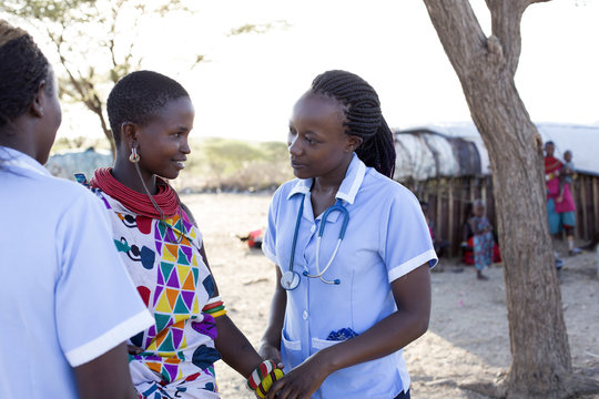 Nurses examing patient in rural village. Kenya, Africa