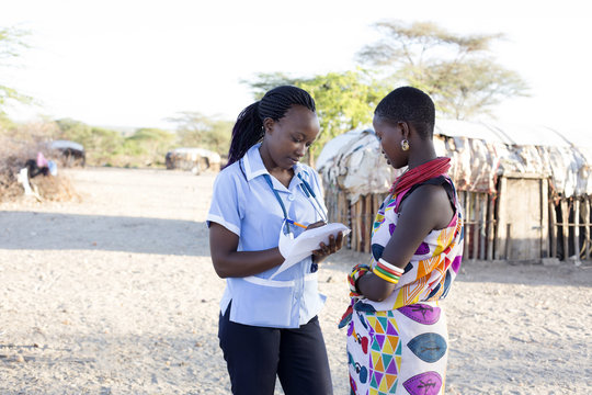 Nurse examing patient in rural village. Kenya, Africa