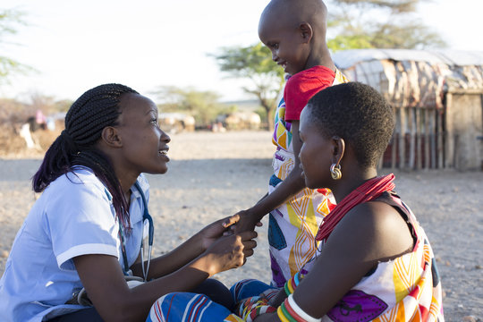 Nurse examing Mother and Daughter in rural village. Kenya, Africa.