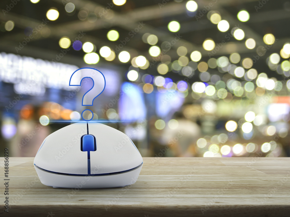 Aufkleber question mark sign icon with wireless computer mouse on wooden table over blur light and shadow of s