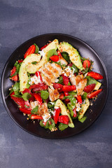 Chicken, strawberry, avocado and spinach salad with almonds. View from above, top studio shot