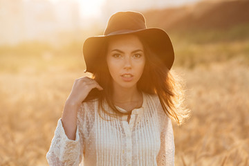 Beautiful young woman standing in the field