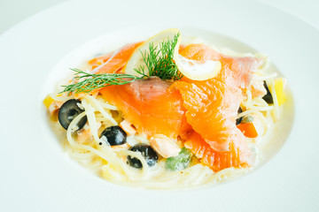 Pasta or Spaghetti cream sauce with salmon meat and lemon on top