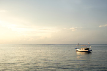 small fisher boat on java sea at sunrise