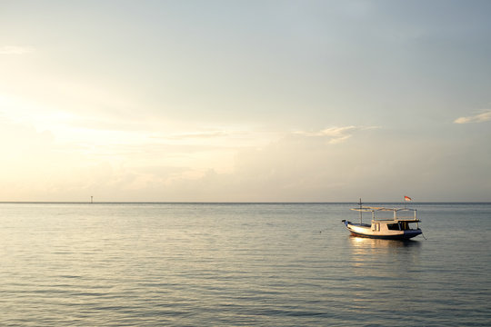 small fisher boat on java sea at sunrise