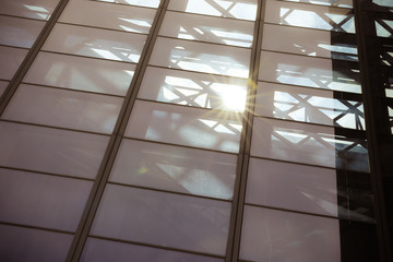 Sun light through blue glass corporate business building architecture background - with copyspace