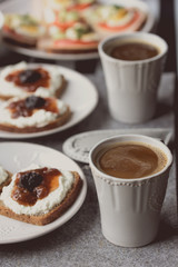 Breakfast with dark bread, white cheese , jam and coffee.  