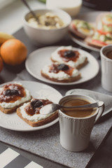Breakfast with dark bread, white cheese , jam and coffee.  
