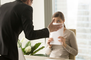 Angry irritated boss reprimanding employee afraid to be fired, accusing of mistake in report, bad...