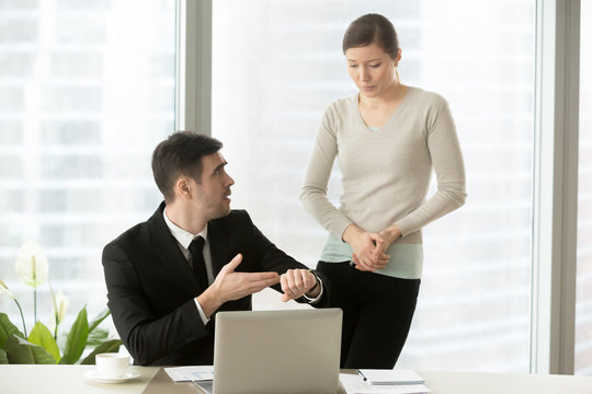 Irritated boss pointing on wristwatch, dissatisfied ceo demanding explanations of female manager, nervous employee making excuses for missed deadline, intern apologizing for being tardy, coming late