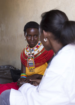 Female Doctor examing woman from Samburu tribe. Kenya, Africa.