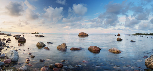 Rocky shores at the sea in sunset light. Lahemaa natural park coastal landscape with beautiful sky
