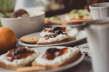 Breakfast with dark bread, white cheese , jam and coffee.  
