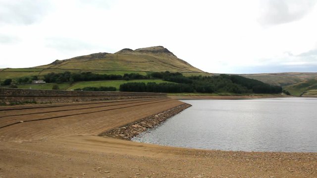 Dovestone reservoir with Saddleworth Moor at end of summer. The reservoir is at a low level following a relatively dry summer in 2013, but not yet so low as to cause concern about water supplies.