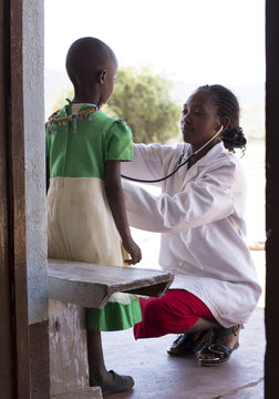 Female Doctor examining child (female).