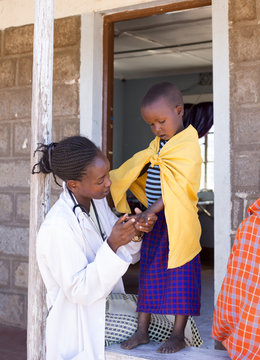 Doctor examing child (girl). Kenya, Africa.