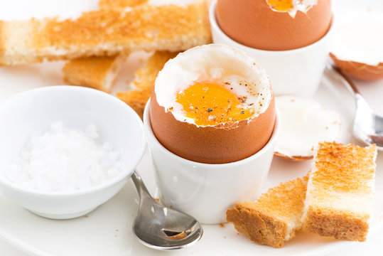 soft boiled eggs and crispy toast for breakfast