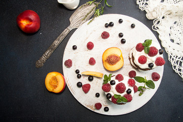 Chocolate cake decorated with raspberry, black currant, nectarine, wipped cream and mint.