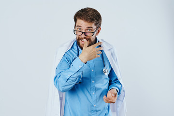 Man with beard wearing glasses on white isolated background in medical dressing gown, doctor, medicine