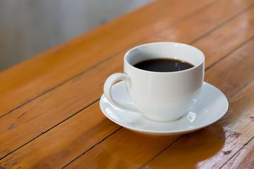 Hot coffee in a white cup on the table.