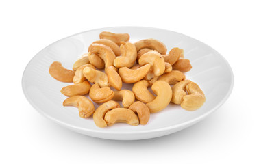 Cashews in white plate isolated on a white background