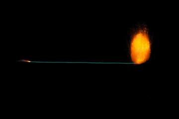 Burning fuse with realistic fiery explosion at the end, orange color with sparks isolated on black background