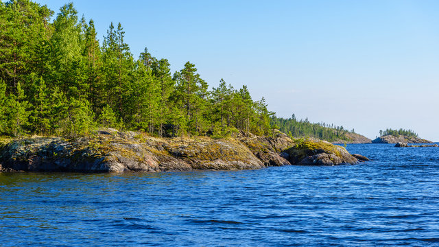 The shores of the straits often have a rounded shape. Ladoga lake skerries, Pitkyaranta, Karelia, Russia.