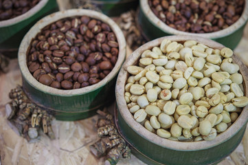 Coffee beans in bamboo tray  on brown wooden background