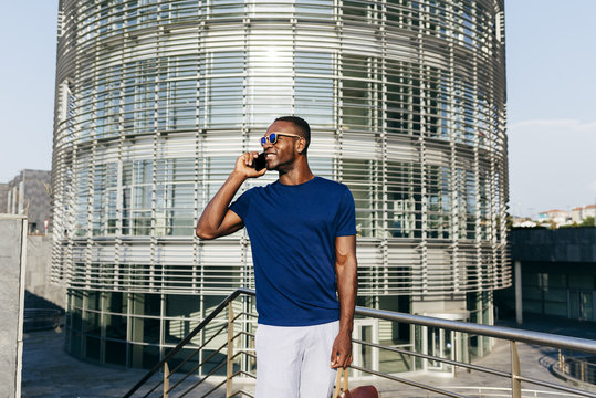 Fashionable male model talking phone at street