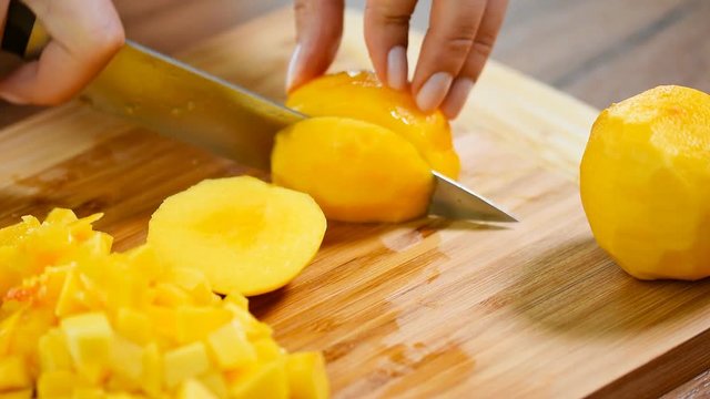 Girl peach slices on a wooden Board