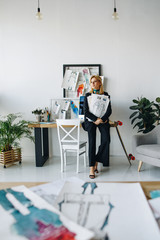 young fashion designer with sketches