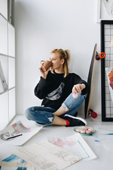 fashion designer with cup and macarons