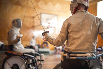 disabled fencers and their trainer at workout