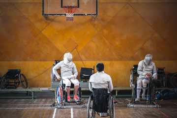 training disabled fencers sitting on a wheelchair