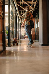Obraz premium Young man skateboarding in modern office
