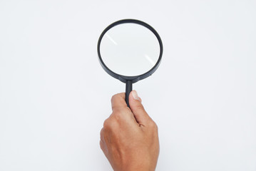 Hand Holding Magnifying Glass Over White Background